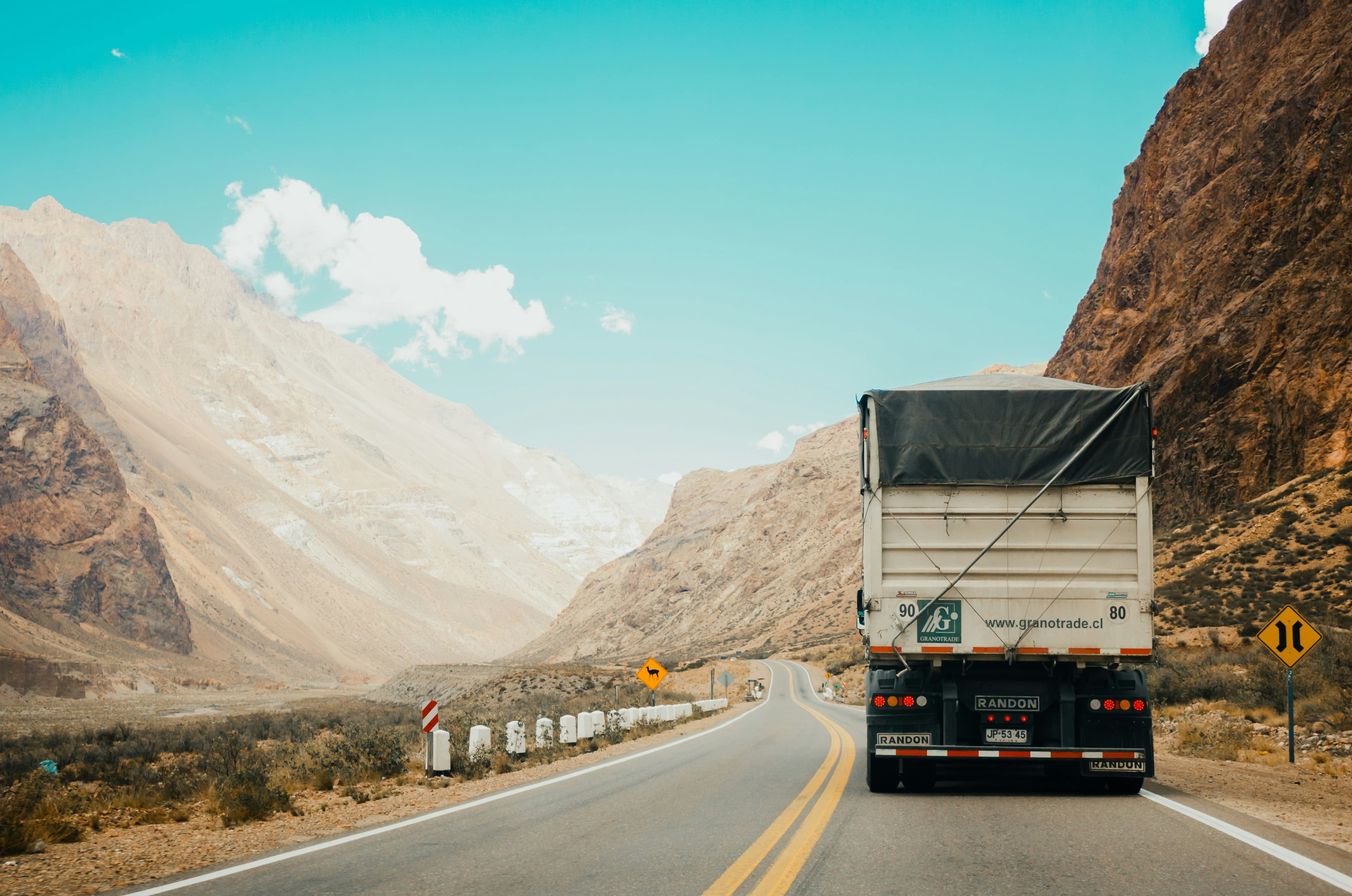 Truck driver reviewing GPS navigation for FTL shipment route across India